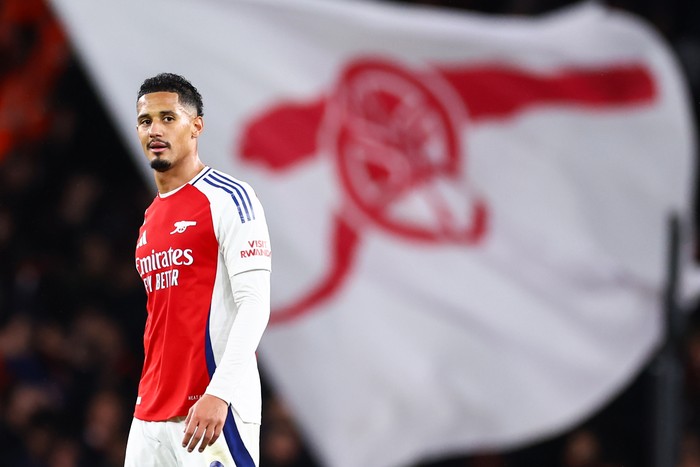 LONDON, ENGLAND - DECEMBER 3: William Saliba of Arsenal with a cannon flag behind him during the Premier League match between Arsenal FC and Manchester United FC at Emirates Stadium on December 3, 2024 in London, England. (Photo by Jacques Feeney/Offside/Offside via Getty Images)