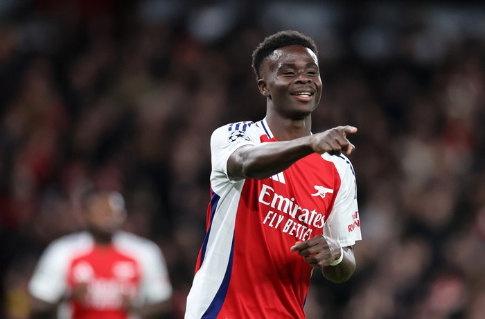 LONDON, ENGLAND - DECEMBER 11: Bukayo Saka of Arsenal celebrates after scoring a goal to make it 1-0 during the UEFA Champions League 2024/25 League Phase MD6 match between Arsenal FC and AS Monaco at Emirates Stadium on December 11, 2024 in London, England. (Photo by Catherine Ivill - AMA/Getty Images)