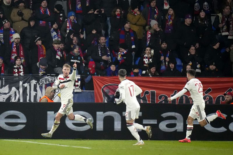 Manchester United's Rasmus Hojlund, left, celebrates after scoring during the Europa League soccer match between Viktoria Plzen and Manchester United at the Doosan Arena in Plzen, Czech Republic, Thursday, Dec. 12, 2024. (AP Photo/Petr David Josek)