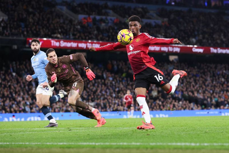 MANCHESTER, ENGLAND - DECEMBER 15: Amad Diallo of Manchester United scores their side's second goal during the Premier League match between Manchester City FC and Manchester United FC at Etihad Stadium on December 15, 2024 in Manchester, England. (Photo by Alex Livesey - Danehouse/Getty Images)
