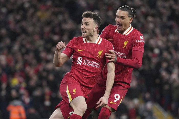 Liverpools Diogo Jota, left, celebrates with Liverpools Darwin Nunez after scoring his sides second goal during the English Premier League soccer match between Liverpool and Fulham, at Anfield stadium in Liverpool, England, Saturday, Dec. 14, 2024. (AP Photo/Jon Super)