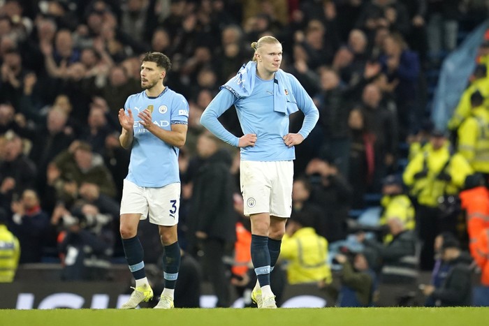 Manchester Citys Erling Haaland, right, and Manchester Citys Ruben Dias react disappointed after the English Premier League soccer match between Manchester City and Manchester United at the Etihad Stadium in Manchester, Sunday, Dec. 15, 2024. (AP Photo/Dave Thompson)