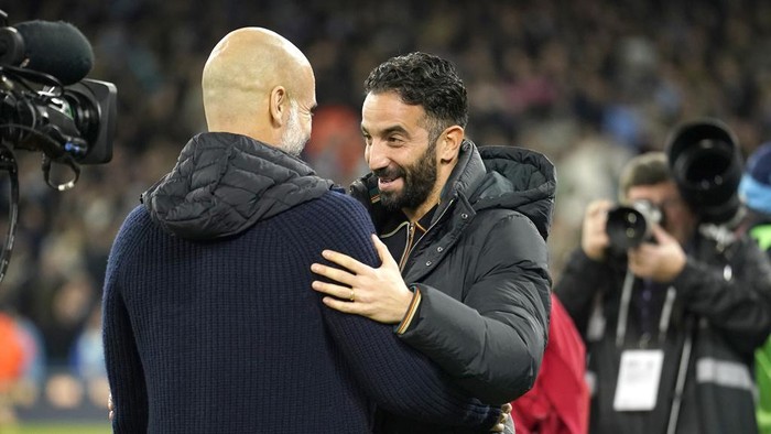 Manchester Citys head coach Pep Guardiola, left, and Manchester Uniteds manager Rúben Amorim meet ahead the English Premier League soccer match between Manchester City and Manchester United at the Etihad Stadium in Manchester, Sunday, Dec. 15, 2024. (AP Photo/Dave Thompson)