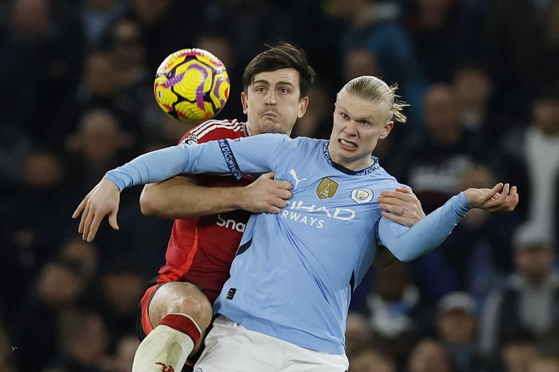 Soccer Football - Premier League - Manchester City v Manchester United - Etihad Stadium, Manchester, Britain - December 15, 2024 Manchester United's Harry Maguire in action with Manchester City's Erling Haaland Action Images via Reuters/Jason Cairnduff EDITORIAL USE ONLY. NO USE WITH UNAUTHORIZED AUDIO, VIDEO, DATA, FIXTURE LISTS, CLUB/LEAGUE LOGOS OR 'LIVE' SERVICES. ONLINE IN-MATCH USE LIMITED TO 120 IMAGES, NO VIDEO EMULATION. NO USE IN BETTING, GAMES OR SINGLE CLUB/LEAGUE/PLAYER PUBLICATIONS. PLEASE CONTACT YOUR ACCOUNT REPRESENTATIVE FOR FURTHER DETAILS..