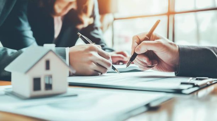 Business Signing a Contract Buy - sell house.