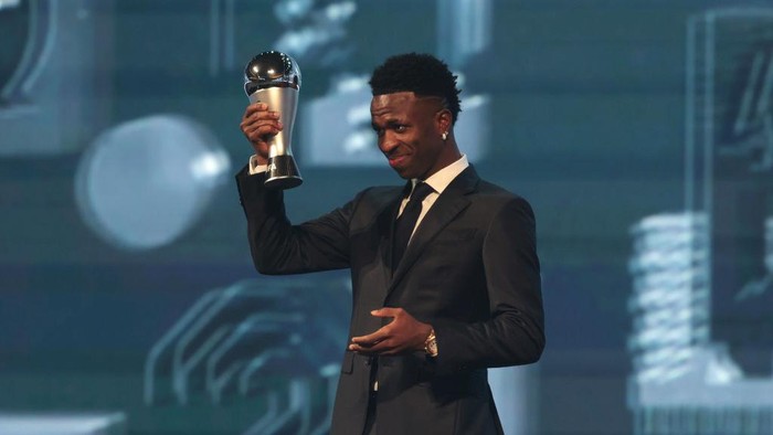 DOHA, QATAR - DECEMBER 17: Vinicius Junior of Real Madrid, seen with The Best FIFA Mens Player Award, leaves the venue with Florentino Perez, President of Real Madrid, following the The Best FIFA Football Awards 2024 at Aspire Academy on December 17, 2024 in Doha, Qatar. (Photo by Christopher Pike - FIFA/FIFA via Getty Images)