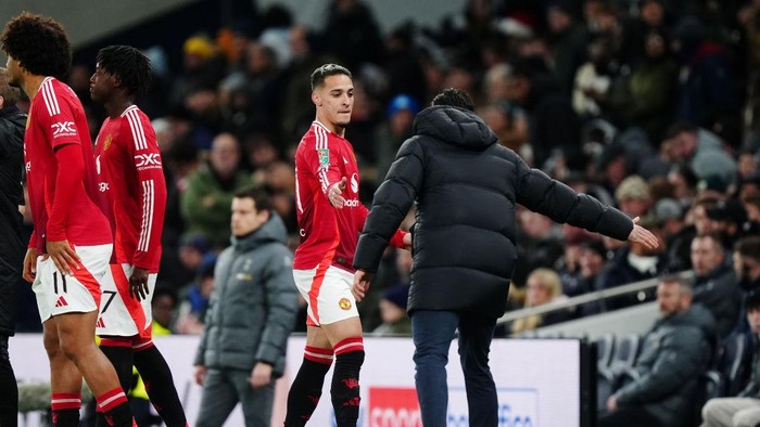 Manchester Uniteds Antony is embraced by manager Ruben Amorim (right) on the touchline during the Carabao Cup quarter-final match at the Tottenham Hotspur Stadium, London. Picture date: Thursday December 19, 2024. (Photo by Mike Egerton/PA Images via Getty Images)
