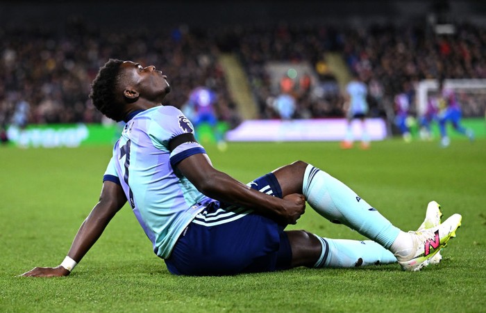 LONDON, ENGLAND - DECEMBER 21: Bukayo Saka of Arsenal reacts after picking up an injury, before receiving medical treatment and leaving the field,  during the Premier League match between Crystal Palace FC and Arsenal FC at Selhurst Park on December 21, 2024 in London, England. (Photo by David Price/Arsenal FC via Getty Images)