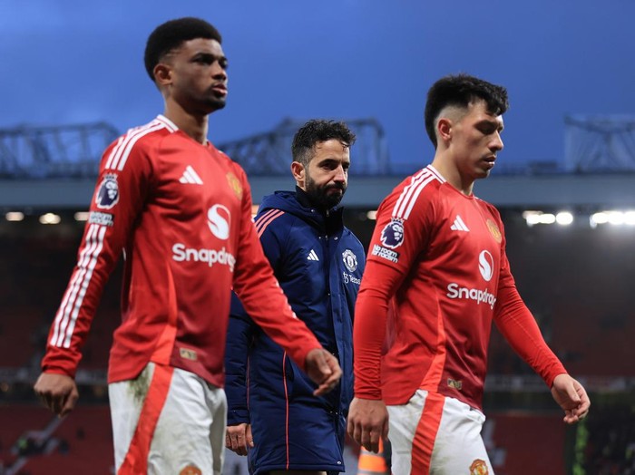 MANCHESTER, ENGLAND - DECEMBER 22: Manchester United manager Ruben Amorim walks off between Amad Diallo of Manchester United (L) and Lisandro Martinez of Manchester United after the Premier League match between Manchester United FC and AFC Bournemouth at Old Trafford on December 22, 2024 in Manchester, England. (Photo by Simon Stacpoole/Offside/Offside via Getty Images)