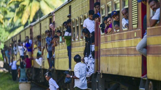 A train 'Queen of the Sea' arrives with family members of the victims on-board at a special memorial monument to commemorate the 20th anniversary of the 2004 tsunami, in Peraliya on December 26, 2024. On December 26, 2004, a magnitude 9.1 earthquake struck the coast of Sumatra in Indonesia and triggered a huge tsunami across the Indian Ocean that killed more than 220,000 people in a dozen countries. (Photo by Ishara S. KODIKARA / AFP)