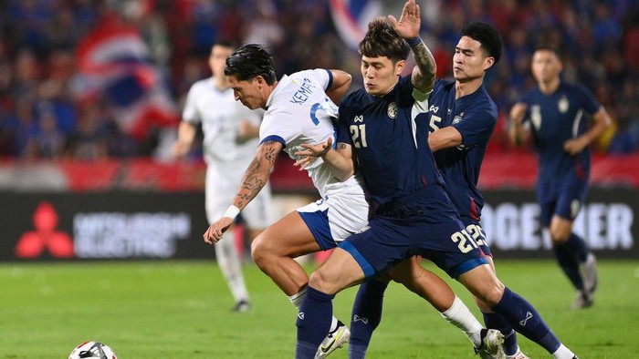 BANGKOK, THAILAND - DECEMBER 30: Michael Kempter of Philippines (L) is tackled by Suphanan Bureerat of Thailand (C) during the ASEAN Mitsubishi Electric Cup 2024 Semi Final second leg match between Thailand and Philippines at Rajamangala National Stadium on December 30, 2024 in Bangkok, Thailand. (Photo by Apinya Rittipo/Getty Images)