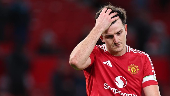 MANCHESTER, ENGLAND - DECEMBER 30: A dejected Harry Maguire of Manchester United walks off at full time during the Premier League match between Manchester United FC and Newcastle United FC at Old Trafford on December 30, 2024 in Manchester, England. (Photo by Robbie Jay Barratt - AMA/Getty Images)