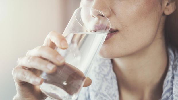 Young woman drinking pure glass of water