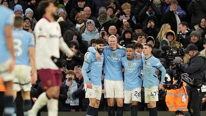 Manchester Citys Erling Haaland (third right) celebrates with team-mates after scoring their sides third goal of the game during the Premier League match at the Etihad Stadium, Manchester. Picture date: Saturday January 4, 2025. (Photo by Martin Rickett/PA Images via Getty Images)