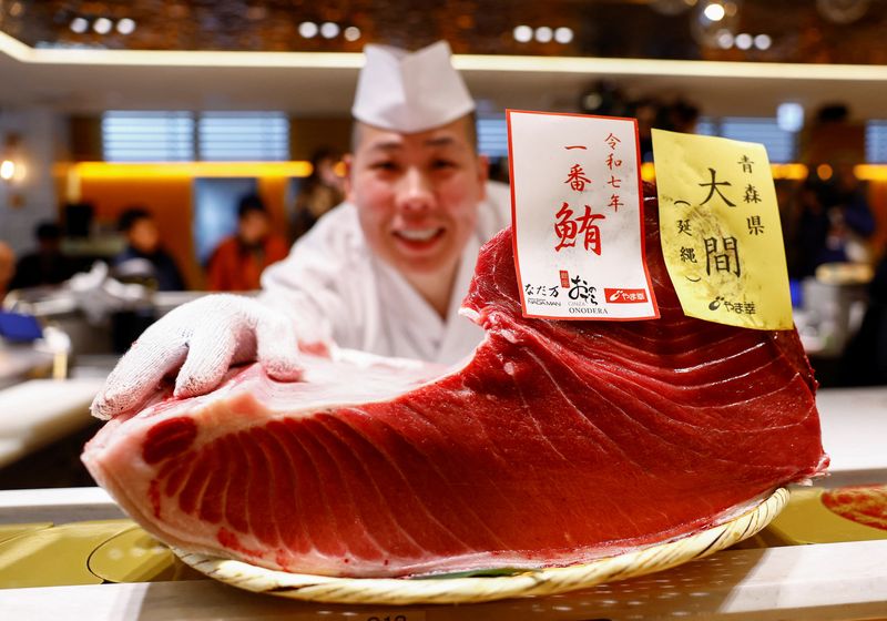 A 276-kilogram bluefin tuna that was auctioned for 207 million Japanese yen (about 1.3 million U.S. dollars), which was bought jointly by sushi restaurant operator Onodera Group and wholesaler Yamayuki, is carried into an Onodera sushi restaurant after the first tuna auction of the New Year in Tokyo, Japan January 5, 2025.  REUTERS/Issei Kato