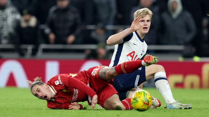 LONDON, ENGLAND - JANUARY 8: Kostas Tsimikas of Liverpool is fouled by Lucas Bergvall of Tottenham Hotspur who escaped a second yellow card for the challenge during the Carabao Cup Semi Final First Leg match between Tottenham Hotspur and Liverpool at Tottenham Hotspur Stadium on January 8, 2025 in London, England. (Photo by Charlotte Wilson/Offside/Offside via Getty Images)