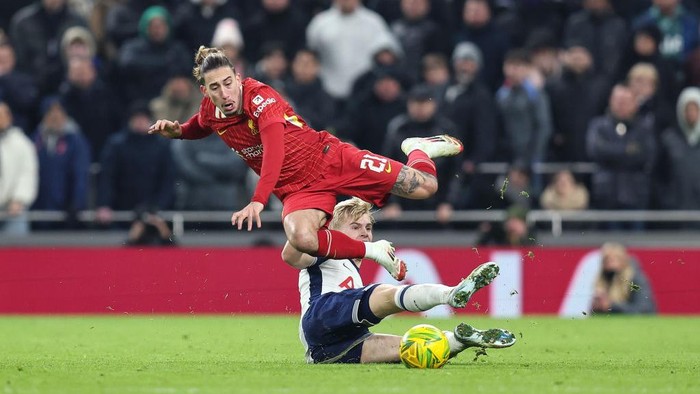 LONDON, ENGLAND - JANUARY 8: Kostas Tsimikas of Liverpool is fouled by Lucas Bergvall of Tottenham Hotspur who escaped a second yellow card for the challenge during the Carabao Cup Semi Final First Leg match between Tottenham Hotspur and Liverpool at Tottenham Hotspur Stadium on January 8, 2025 in London, England. (Photo by Charlotte Wilson/Offside/Offside via Getty Images)