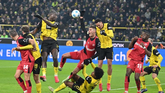 Bundesliga 10 January 2025, North Rhine-Westphalia, Dortmund: Soccer, Bundesliga, Borussia Dortmund - Bayer Leverkusen, Matchday 16, Signal Iduna Park, Dortmunds Karim Adeyemi (u) and Leverkusens Patrik Schick (M) fight for the ball. IMPORTANT NOTE: In accordance with the regulations of the DFL German Football League and the DFB German Football Association, it is prohibited to use or have used photographs taken in the stadium and/or of the match in the form of sequential images and/or video-like photo series. Photo: Bernd Thissen/dpa (Photo by Bernd Thissen/picture alliance via Getty Images)