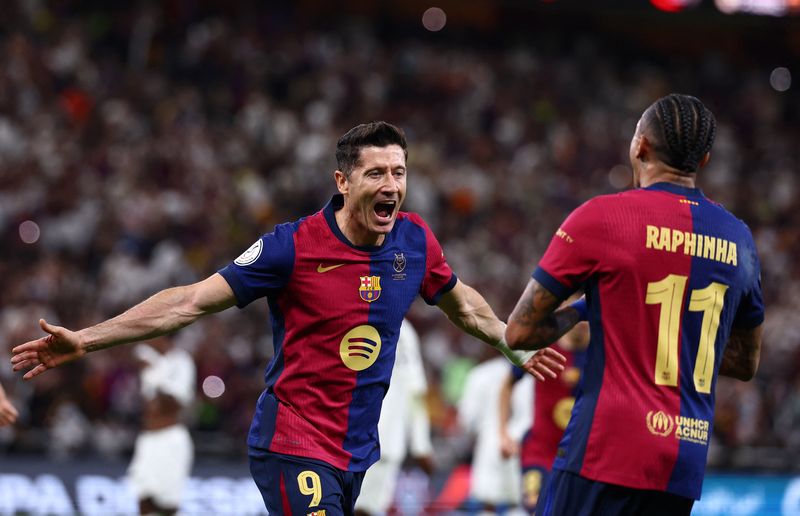 Soccer Football - Spanish Super Cup - Final - FC Barcelona v Real Madrid - King Abdullah Sports City, Jeddah, Saudi Arabia - January 12, 2025 FC Barcelona's Robert Lewandowski celebrates with Raphinha after scoring their second goal REUTERS/Pedro Nunes