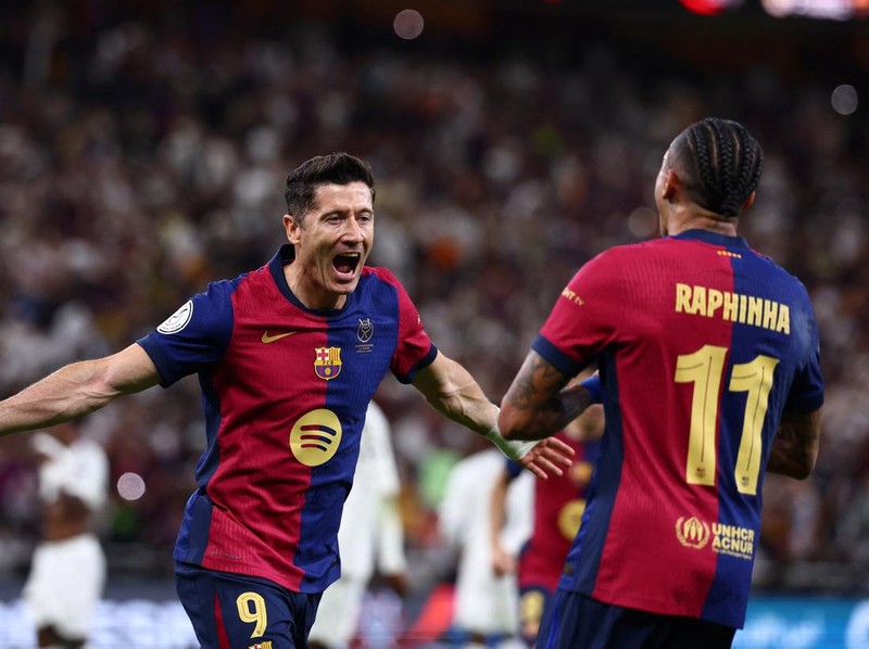 Soccer Football - Spanish Super Cup - Final - FC Barcelona v Real Madrid - King Abdullah Sports City, Jeddah, Saudi Arabia - January 12, 2025 FC Barcelona's Robert Lewandowski celebrates with Raphinha after scoring their second goal REUTERS/Pedro Nunes