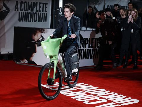 US-French actor Timothee Chalamet arrives on a LIME ebike to pose on the red carpet upon arrival for the UK Premier of the movie 