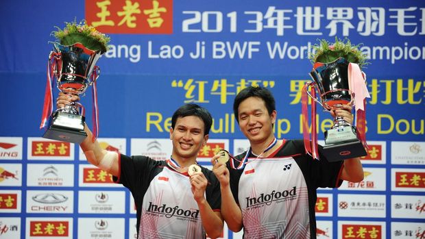 Indonesia's Mohammad Ahsan (L) and Hendra Setiawan (R) pose with their trophy after winning their men's doubles final against Denmark's Mathias Boe and Carsten Mogensen at World Badminton Championships in Guangzhou, south China's Guangdong province on August 11, 2013. Mohammad Ahsan and Hendra Setiawan won 21-13 23-21.   CHINA OUT     AFP PHOTO (Photo by AFP)