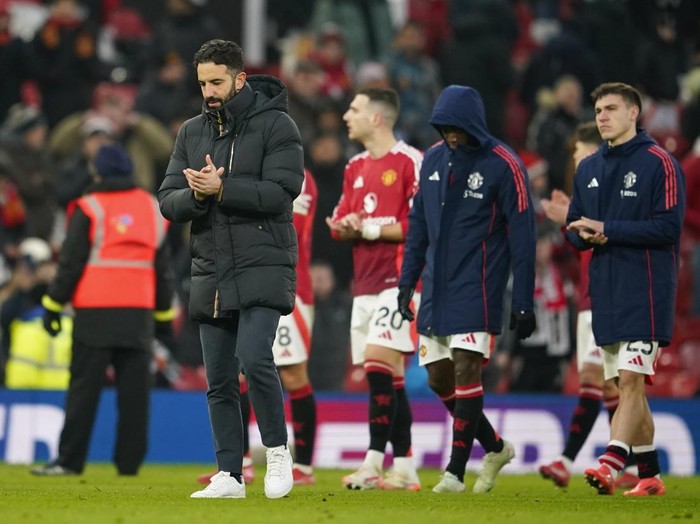 Manchester Uniteds head coach Ruben Amorim, left, walks on the pitch at the end of the English Premier League soccer match between Manchester United and Brighton and Hove Albion, at the Old Trafford stadium in Manchester, England, Sunday, Jan. 19, 2025. (AP Photo/Dave Thompson)