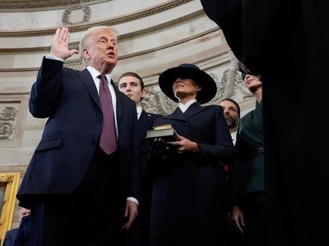 Donald Trump is sworn in as the 47th president of the United States by Chief Justice John Roberts as Melania Trump holds the Bible during the 60th Presidential Inauguration in the Rotunda of the U.S. Capitol in Washington, Monday, Jan. 20, 2025.     Morry Gash/Pool via REUTERS