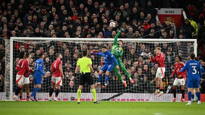Manchester Uniteds Turkish goalkeeper #01 Altay Bayindir C) saves the ball from entering the goal during the UEFA Europa league football match between Manchester United and Glasgow Rangers at Old Trafford stadium in Manchester, north west England, on January 23, 2025. (Photo by Oli SCARFF / AFP)