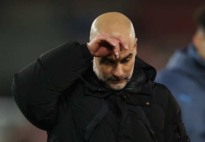 FILE PHOTO: Soccer Football - Premier League - Brentford v Manchester City - GTech Community Stadium, London, Britain - January 14, 2025 Manchester City manager Pep Guardiola looks dejected after the match REUTERS/Toby Melville EDITORIAL USE ONLY. NO USE WITH UNAUTHORIZED AUDIO, VIDEO, DATA, FIXTURE LISTS, CLUB/LEAGUE LOGOS OR LIVE SERVICES. ONLINE IN-MATCH USE LIMITED TO 120 IMAGES, NO VIDEO EMULATION. NO USE IN BETTING, GAMES OR SINGLE CLUB/LEAGUE/PLAYER PUBLICATIONS. PLEASE CONTACT YOUR ACCOUNT REPRESENTATIVE FOR FURTHER DETAILS../File Photo