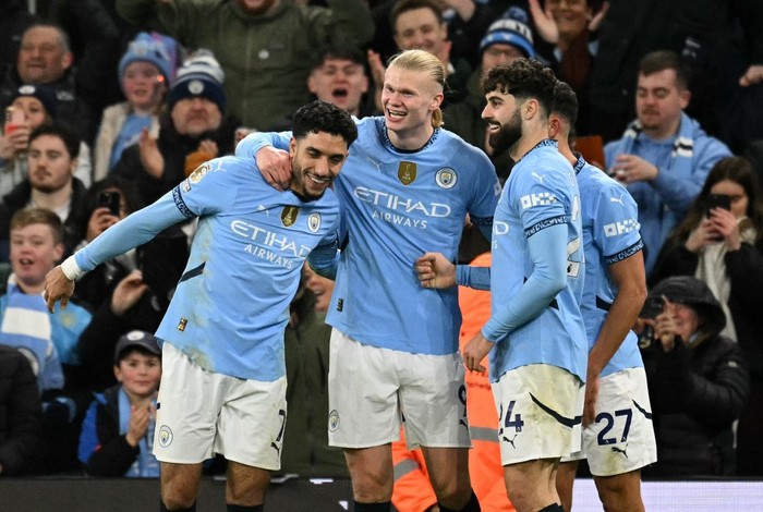 Manchester City's Norwegian striker #09 Erling Haaland  celebrates scoring the team's second goal with Manchester City's Egyptian striker #07 Omar Marmoush (L) and Manchester City's Croatian defender #24 Josko Gvardiolduring the English Premier League football match between Manchester City and Chelsea at the Etihad Stadium in Manchester, north west England, on January 25, 2025. (Photo by Oli SCARFF / AFP) / RESTRICTED TO EDITORIAL USE. No use with unauthorized audio, video, data, fixture lists, club/league logos or 'live' services. Online in-match use limited to 120 images. An additional 40 images may be used in extra time. No video emulation. Social media in-match use limited to 120 images. An additional 40 images may be used in extra time. No use in betting publications, games or single club/league/player publications. /