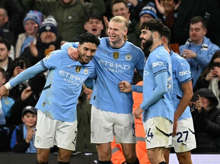 Manchester City's Norwegian striker #09 Erling Haaland  celebrates scoring the team's second goal with Manchester City's Egyptian striker #07 Omar Marmoush (L) and Manchester City's Croatian defender #24 Josko Gvardiolduring the English Premier League football match between Manchester City and Chelsea at the Etihad Stadium in Manchester, north west England, on January 25, 2025. (Photo by Oli SCARFF / AFP) / RESTRICTED TO EDITORIAL USE. No use with unauthorized audio, video, data, fixture lists, club/league logos or 'live' services. Online in-match use limited to 120 images. An additional 40 images may be used in extra time. No video emulation. Social media in-match use limited to 120 images. An additional 40 images may be used in extra time. No use in betting publications, games or single club/league/player publications. /