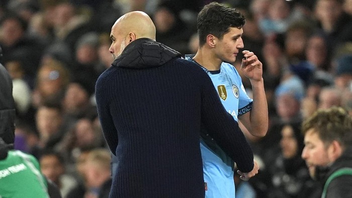 Manchester Citys Abduqodir Khusanov (right) is congratulated by manager Pepe Guardiola after being substituted during the Premier League match at the Etihad Stadium, Manchester. Picture date: Saturday January 25, 2025. (Photo by Martin Rickett/PA Images via Getty Images)