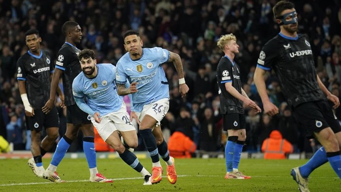 Manchester Citys Savinho, center, celebrates after scoring his sides third goal during the Champions League opening phase soccer match between Manchester City and Club Brugge at the Etihad Stadium in Manchester, Wednesday, Jan. 29, 2025. (AP Photo/Dave Thompson)