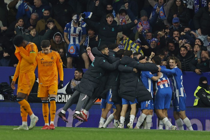 Espanyol players celebrate after Carlos Romero scored the opening goal during a Spanish La Liga soccer match between Espanyol and Real Madrid at the Lluis Companys Olympic Stadium in Barcelona, Spain, Saturday Feb.1, 2025. (AP Photo/Joan Monfort)