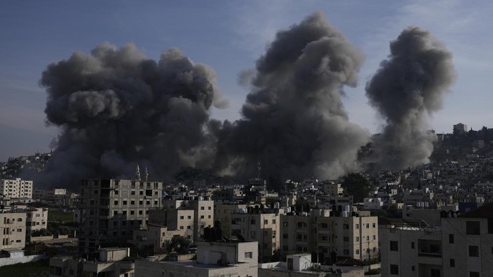 Smoke rises following an explosion detonated by the Israeli army, which said it was destroying buildings used by Palestinian militants in the West Bank Jenin refugee camp, Sunday, Feb. 2, 2025. (AP Photo/Majdi Mohammed)