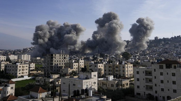 Smoke rises following an explosion detonated by the Israeli army, which said it was destroying buildings used by Palestinian militants in the West Bank Jenin refugee camp, Sunday, Feb. 2, 2025. (AP Photo/Majdi Mohammed)