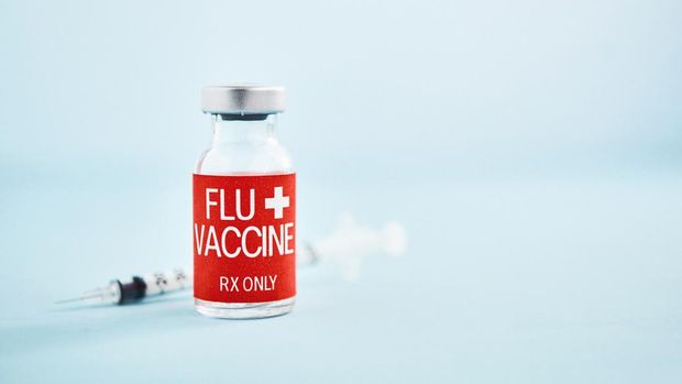Flu vaccine with syringe and copy space