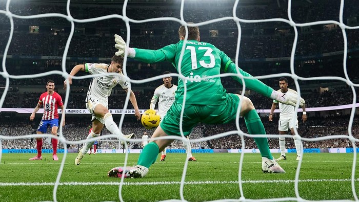 MADRID, SPAIN - FEBRUARY 04: (EDITORS NOTE: In this photo taken from a remote camera from behind the goal.) Jan Oblak of Atletico Madrid fails to save the shot of Brahim Diaz of Real Madrid which results in their first goal during the LaLiga EA Sports match between Real Madrid CF and Atletico Madrid at Estadio Santiago Bernabeu on February 04, 2024 in Madrid, Spain. (Photo by Angel Martinez/Getty Images)