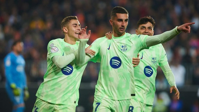 Valencia, Spain - February 6: Ferran Torres of FC Barcelona and Fermin Rodriguez of FC Barcelona celebrates after scoring his teams first goal during the Copa del Rey quarter final match between Valencia CF and FC Barcelona at Estadio Mestalla on February 6, 2025 in Valencia, Spain.