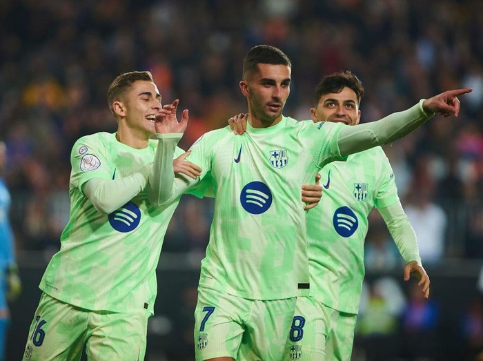 Valencia, Spain - February 6: Ferran Torres of FC Barcelona and Fermin Rodriguez of FC Barcelona celebrates after scoring his team's first goal during the Copa del Rey quarter final match between Valencia CF and FC Barcelona at Estadio Mestalla on February 6, 2025 in Valencia, Spain.
