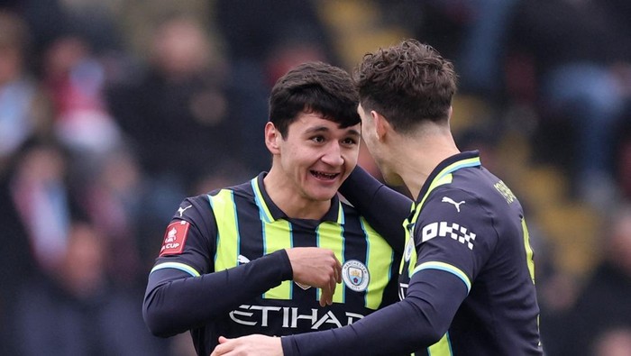 Soccer Football - FA Cup - Fourth Round - Leyton Orient v Manchester City - Brisbane Road, London, Britain - February 8, 2025 Manchester Citys Abdukodir Khusanov celebrates scoring their first goal with Manchester Citys John Stones REUTERS/David Klein