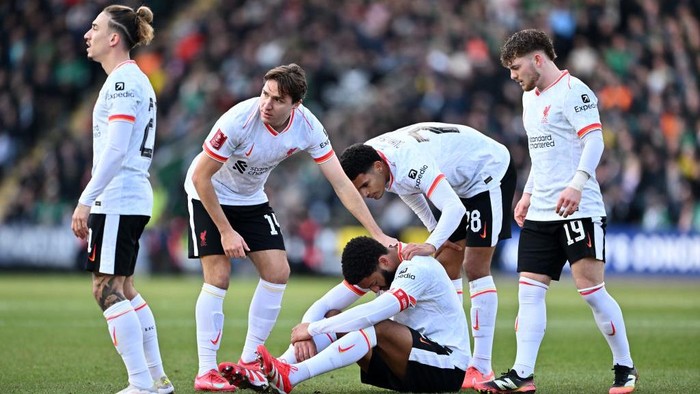 PLYMOUTH, ENGLAND - FEBRUARY 09: Joe Gomez of Liverpool reacts on the floor as Kostas Tsimikas, Federico Chiesa, Jarell Quansah of Liverpool and Harvey Elliott of Liverpool looks on during the Emirates FA Cup Fourth Round match between Plymouth Argyle and Liverpool at Home Park on February 09, 2025 in Plymouth, England. (Photo by Dan Mullan/Getty Images)