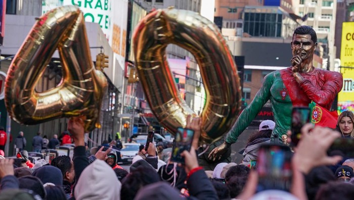 People gather for a statue unveiling in Times Square on the birthday of soccer star Cristiano Ronaldo in New York City, U.S., February 5, 2025. REUTERS/David 'Dee' Delgado