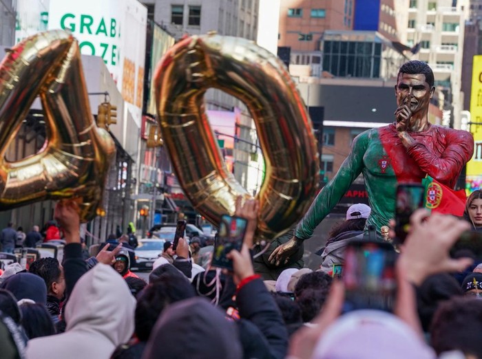 People gather for a statue unveiling in Times Square on the birthday of soccer star Cristiano Ronaldo in New York City, U.S., February 5, 2025. REUTERS/David 'Dee' Delgado