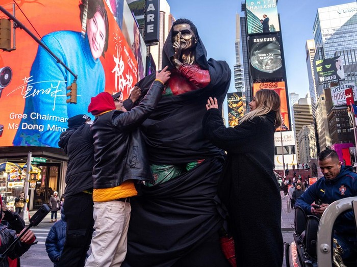 People gather for a statue unveiling in Times Square on the birthday of soccer star Cristiano Ronaldo in New York City, U.S., February 5, 2025. REUTERS/David 'Dee' Delgado