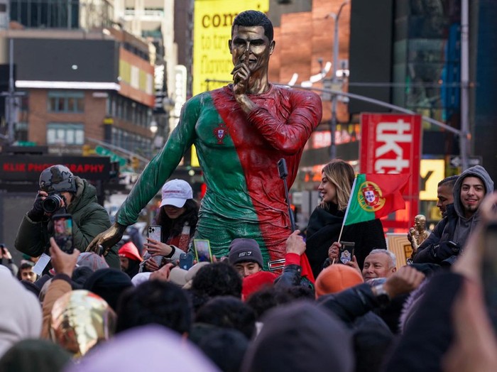 People gather for a statue unveiling in Times Square on the birthday of soccer star Cristiano Ronaldo in New York City, U.S., February 5, 2025. REUTERS/David 'Dee' Delgado