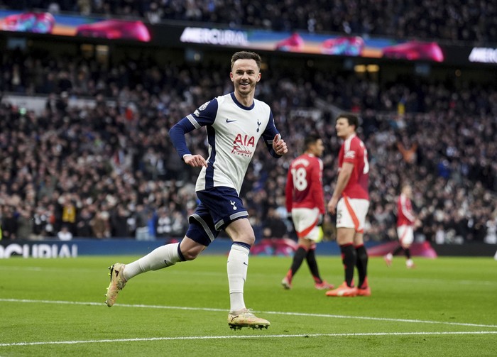 Tottenhams James Maddison celebrates after scoring the opening goal during the English Premier League soccer match between Tottenham Hotspur and Manchester United in London, Sunday, Feb. 16, 2025. (John Walton/PA via AP)
