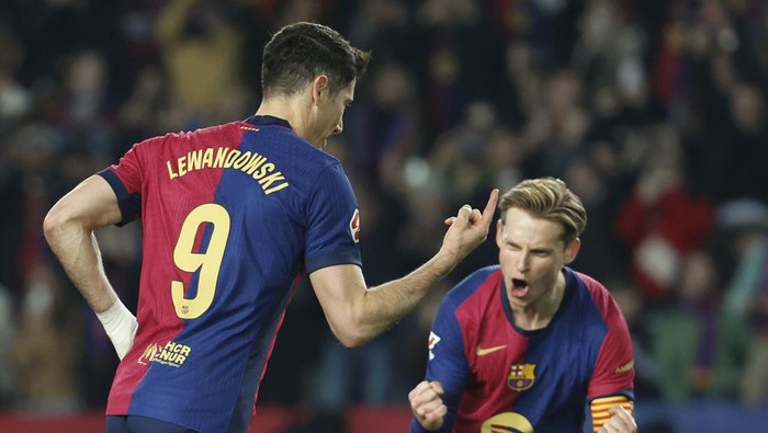 Barcelona Barcelonas Robert Lewandowski celebrates after scoring his sides opening goal during a Spanish La Liga soccer match between Barcelona and Rayo Vallecano at the Lluis Companys Olympic Stadium in Barcelona, Spain, Monday, Feb. 17, 2025. (AP Photo/Joan Monfort)