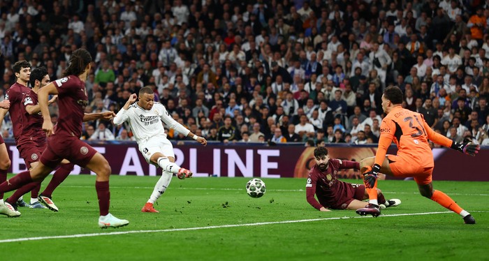 Soccer Football - Champions League - Knockout Phase Playoff - Second Leg - Real Madrid v Manchester City - Santiago Bernabeu, Madrid, Spain - February 19, 2025 Real Madrid's Kylian Mbappe scores their second goal past Manchester City's Ederson Action Images via Reuters/Matthew Childs